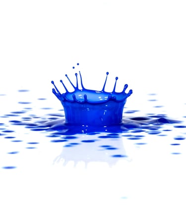 A splash of blue paint on a white surface