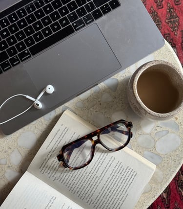 a laptop computer and a cup of coffee on a table