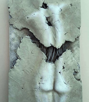 A relief sculpture of a fragmented female (rear view) showing exposed wires, painted cool browns