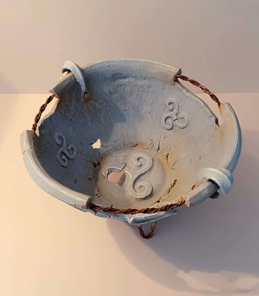 Interior of a round bowl-like sculpture with rusty wire, symbols and letters