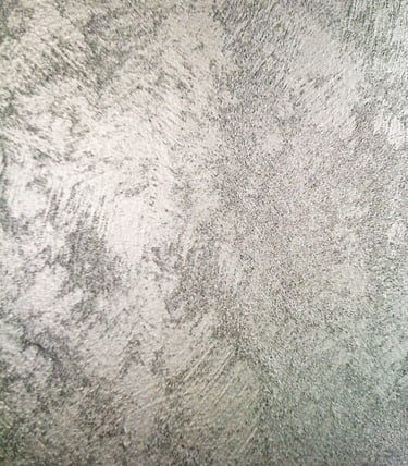 A cool silver paint sample showing off its shimmering grainy texture.