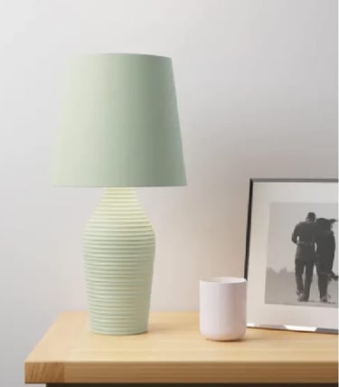 a table lamp with a green lamp shade on it
