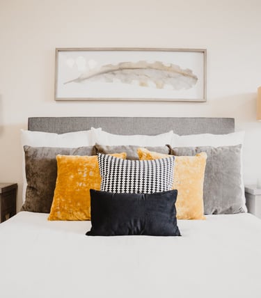 a bed with pillows and pillows on top of a bed