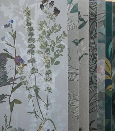 Variety of botanical and textured wallpaper samples featuring floral patterns and marble designs.