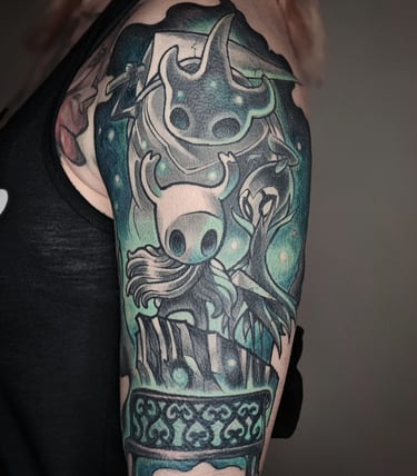 Female upper arm with Hollow Knight half sleeve tattoo.