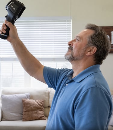 A home inspector uses a FLIR thermal imaging camera to detect heat loss and insulation issues.