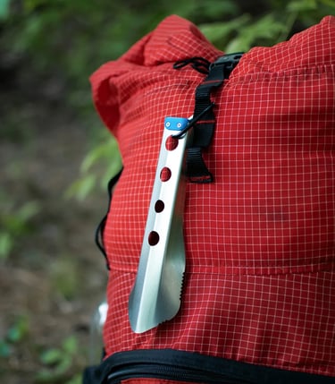 boglerco trowel clipped with carabiner on backpack