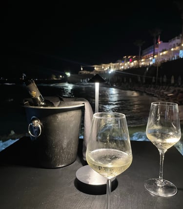 two wine glasses with champagne in front of a boat