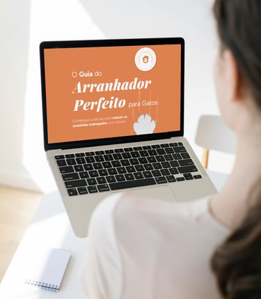 Uma mulher sentada na mesa com um laptop na mão aberto em um ebook guia do arranhador