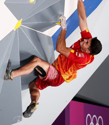 a man bouldering and putting a lot of effort