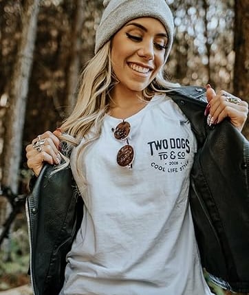 a woman wearing a white t - shirt and a black jacket