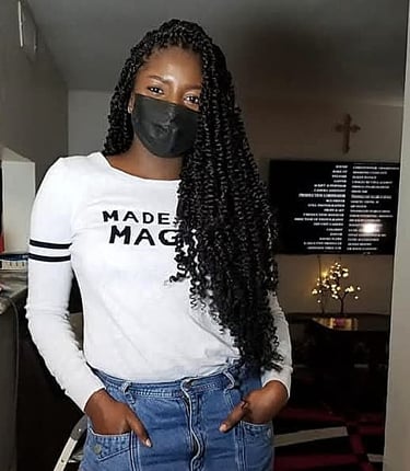 a woman with long black passion twist hairstyle