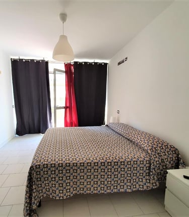 a bed room with a bed and a television