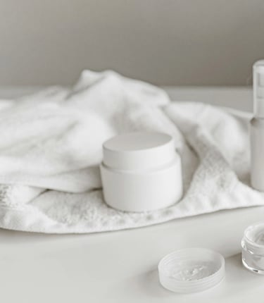 a white table with a towel and some white containers