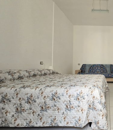 a bedroom with a bed and a television