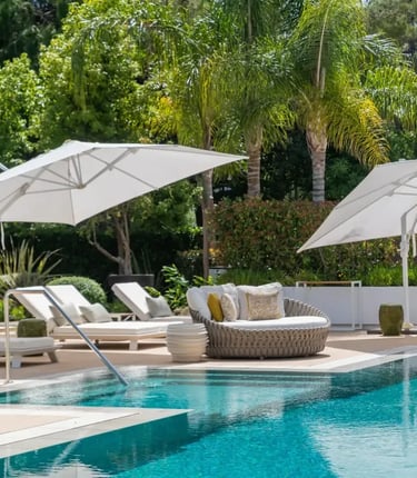 Poolside daybeds with umbrellas at Villa Serenity gardens