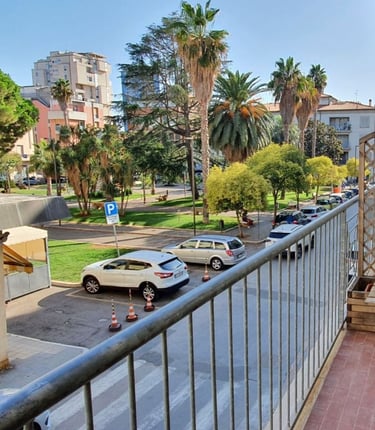 a balcony with a bench and a table with a chair