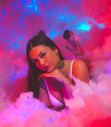 a woman in a white bra top and a pink smoke cloud