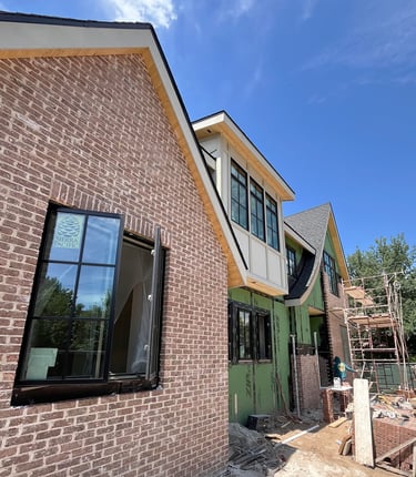 a brick building with a green door and a window