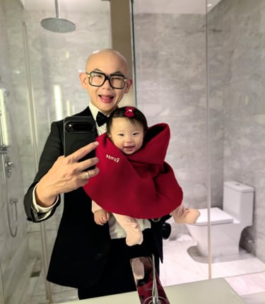 a man in a suit and tie is taking a selfie with his baby