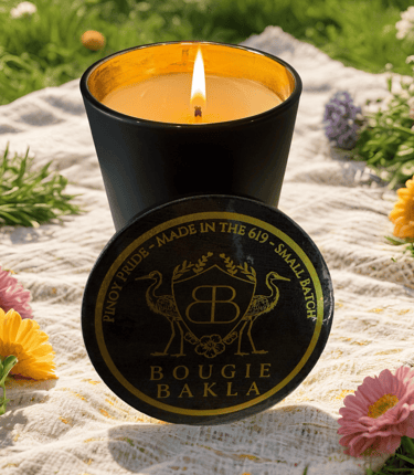 a candle with a candle in a black candle holder