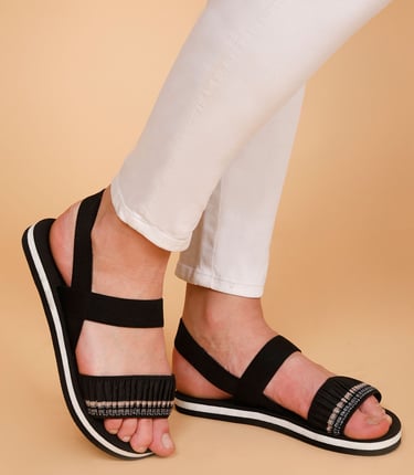 a woman's feet embroidered black sandals