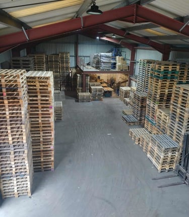 Warehouse with repaired pallets stacked up
