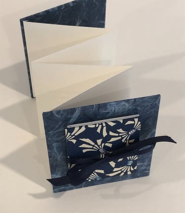 Accordion with Japanese paper and small accordion on cover, ribbon detail