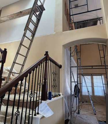 a staircase way with a ladder up to the top of it