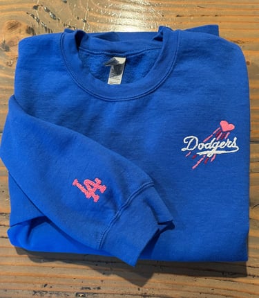a blue sweatshirt with the dodgers logo on it