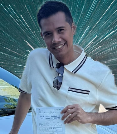 Man holding a certificate of passing a practical driving test in the UK