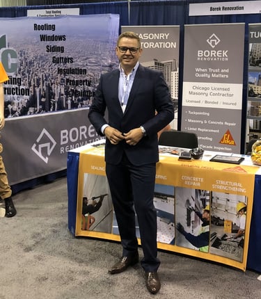 Borek Renovation's owner at a professional trade show booth for masonry restoration.