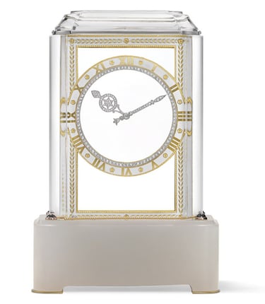 Cartier mystery clock with gold and diamond details on rock crystal.