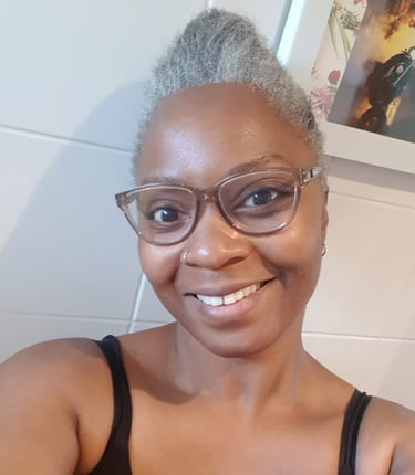 a Black woman with glasses and a black top