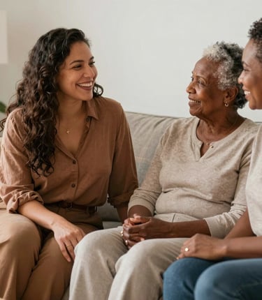 A warm moment between a caregiver and an older adult sharing a smile in a cozy living room.