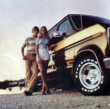 a couple of people standing next to a van