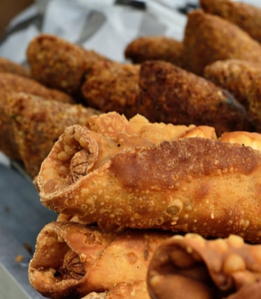 a tray of fried alcapurias and empanadas