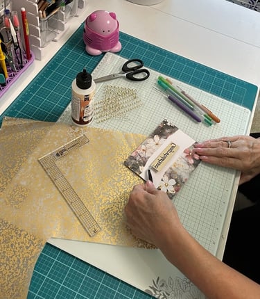 Linda is sitting at her craft desk making a Congratulations card.