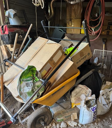 a wheelbarrowd cartonces in a garage