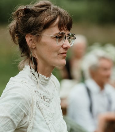 a woman in a white shirt and glasses
