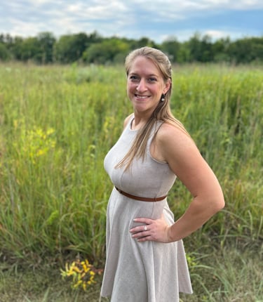 Lauren Witt in a dress standing in a field