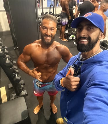 a man with a beard and a beard standing in a gym