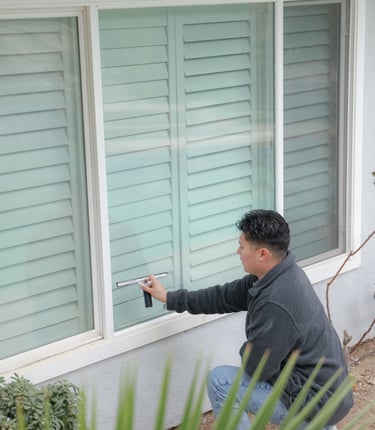 man with squeegee on window 