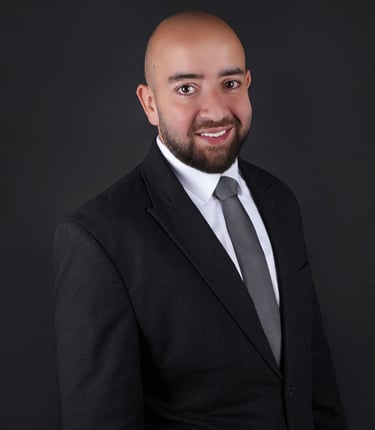 Professional corporate headshot of a confident business executive with a clean, modern backdrop.