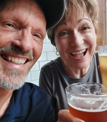 Smiling couple holding glasses of beer