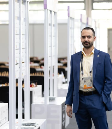 Chess media Vlad Ghita looking towards the camera at the 2024 FIDE Chess Olympiad in Budapest