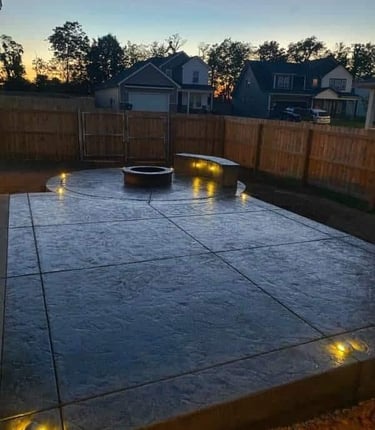 a patio with a fire pit concret floor