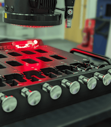 Multi-nest metrology fixture holding small thin medical devices whilst being inspected by an optical CMM.