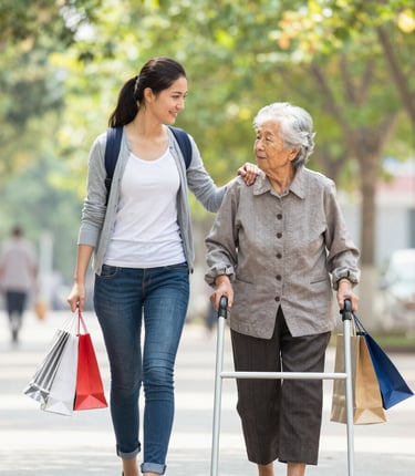 A caring caregiver helping an elderly person with daily tasks in a cozy home setting.