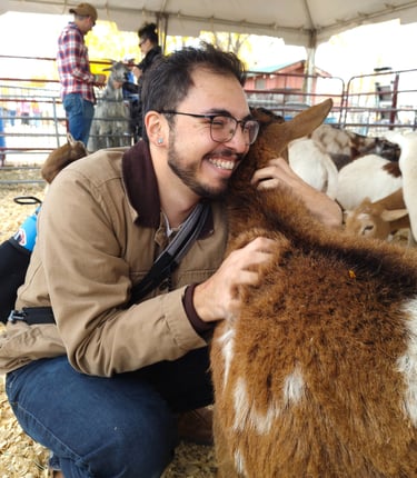 Luis at a petting zoo hugging a goat that took to him very well!